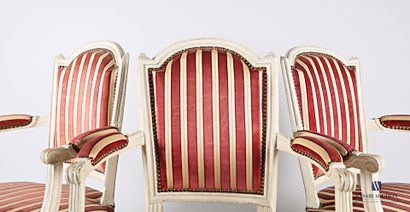 A suite of three moulded wooden armchairs,...