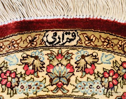 Oval silk carpet decorated with a flowered...