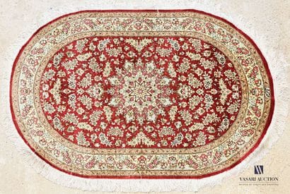 Oval silk carpet decorated with a flowered...
