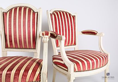 A suite of three moulded wooden armchairs,...