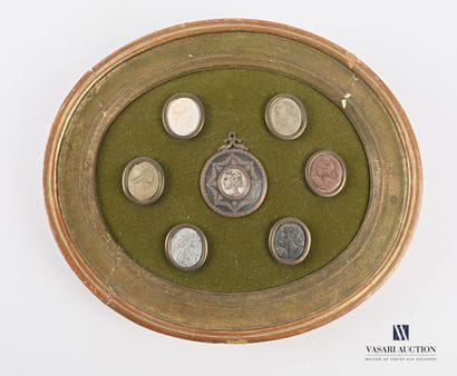 Medallion frame with a winged head profile...