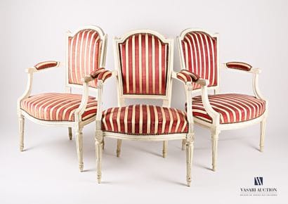 A suite of three moulded wooden armchairs,...