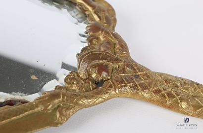 Face to hand in bronze, the bevelled mirror...