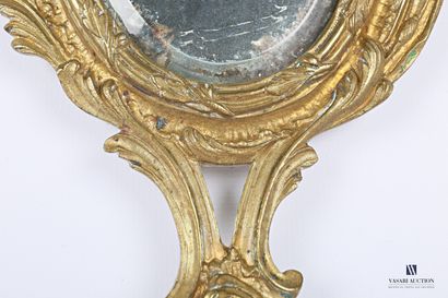 Face to hand in bronze, the bevelled oval...
