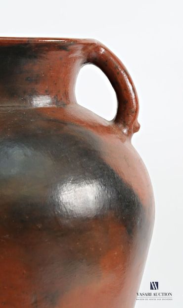 A truncated cone-shaped amphora in patinated...