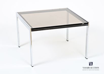 The square-shaped smoked-glass top rests...