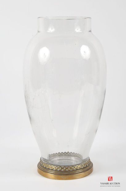 A large ovoid crystal vase, standing on a...