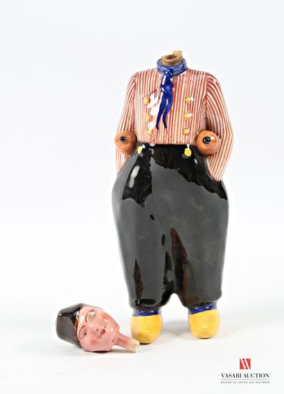 Ceramic bottle featuring a robed man carrying...