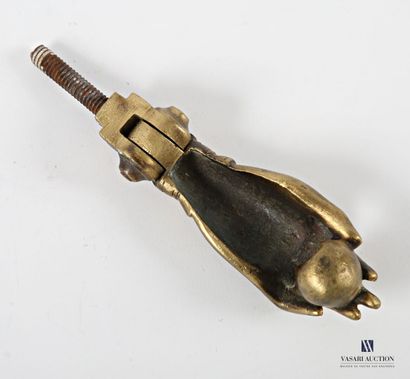 Gilt bronze door knocker featuring a hand...