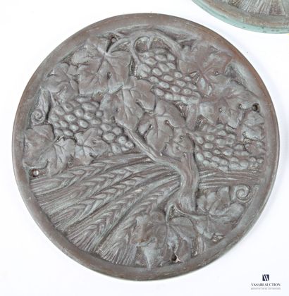 Three cast-iron medallions depicting vine...