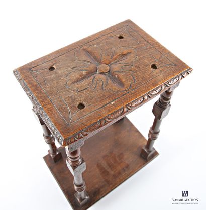 The rectangular top is carved with a flower...