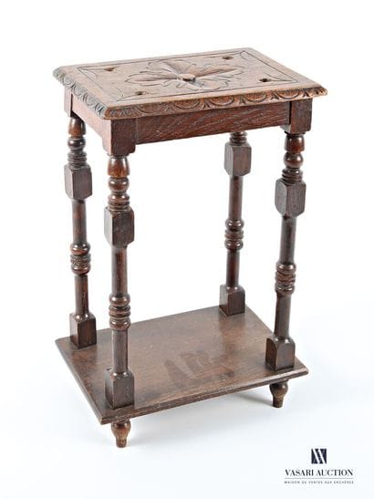 The rectangular top is carved with a flower...