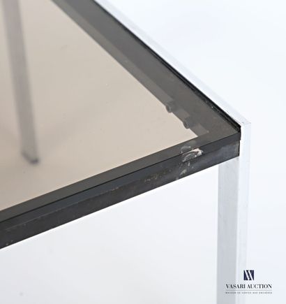 The square-shaped smoked-glass top rests...