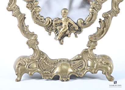 A bronze psyche table mirror, with a curved...