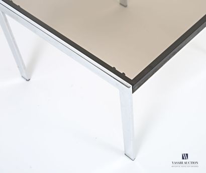 The square-shaped smoked-glass top rests...