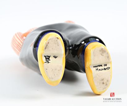 Ceramic bottle featuring a robed man carrying...