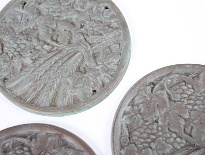 Three cast-iron medallions depicting vine...