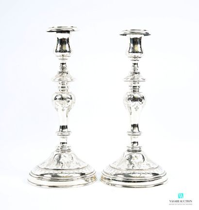 A pair of silver-plated candlesticks on a...