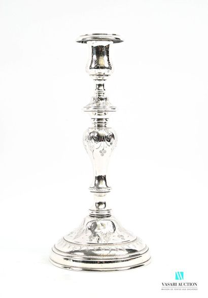 A pair of silver-plated candlesticks on a...