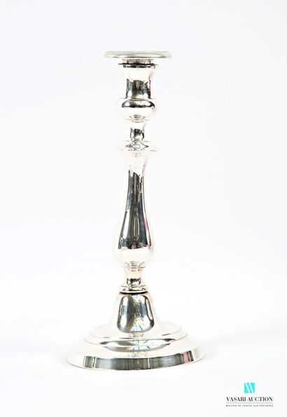A pair of silver-plated candlesticks on a...