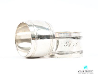 Two napkin rings, one tonneau-shaped, hemmed...