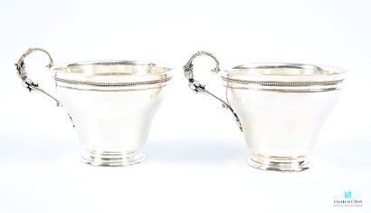 Two silver-plated chocolate cups resting...