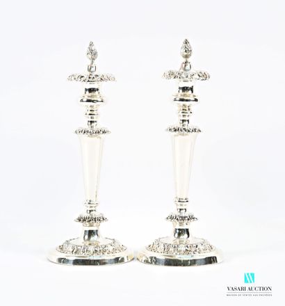 A pair of silver-plated candlesticks on a...