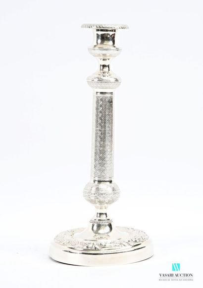 A pair of silver-plated candlesticks on a...