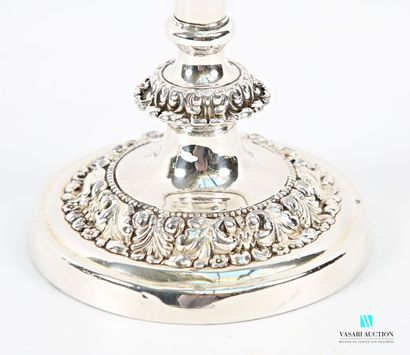 A pair of silver-plated candlesticks on a...