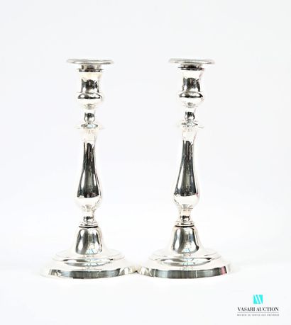 A pair of silver-plated candlesticks on a...