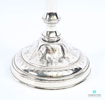 A pair of silver-plated candlesticks on a...