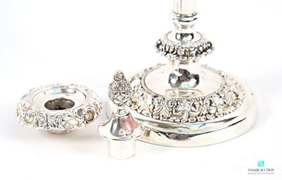 A pair of silver-plated candlesticks on a...
