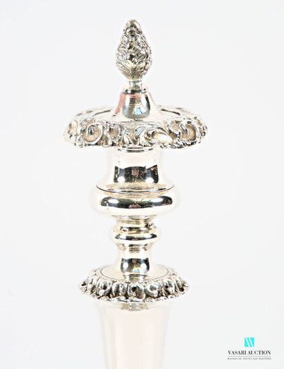 A pair of silver-plated candlesticks on a...