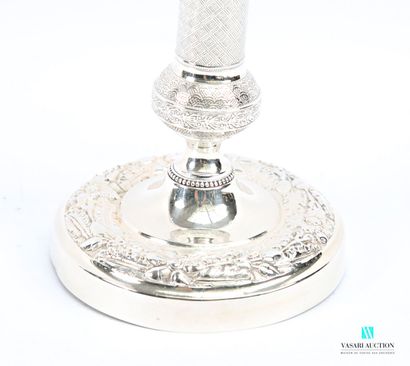 A pair of silver-plated candlesticks on a...