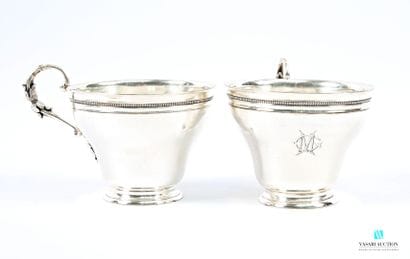 Two silver-plated chocolate cups resting...