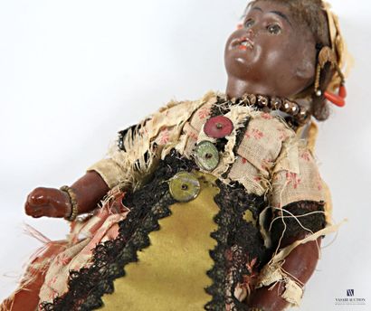 Porcelain-headed doll depicting a woman in...