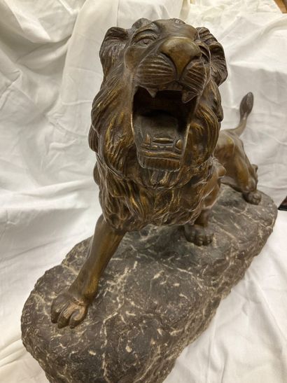 Bronze sculpture of a roaring lion on a granite...