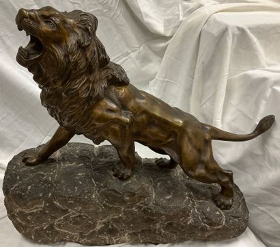 Bronze sculpture of a roaring lion on a granite...