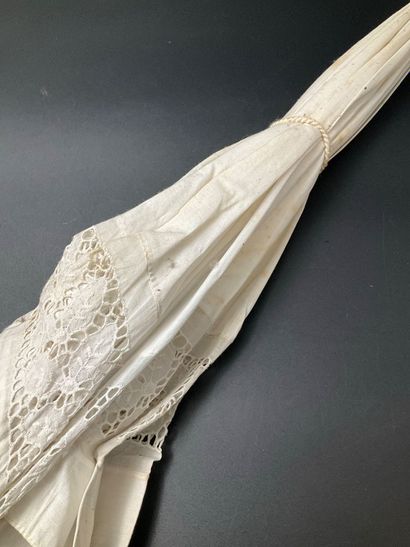 A cotton parasol on a bamboo stem base. A...