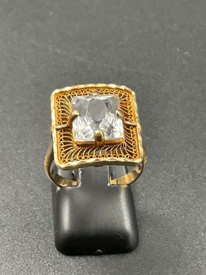 750 thousandths gold ring set with a white...