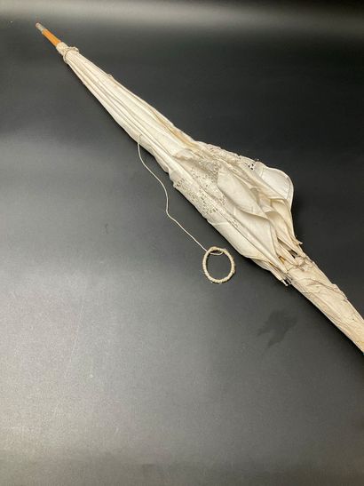 A cotton parasol on a bamboo stem base. A...