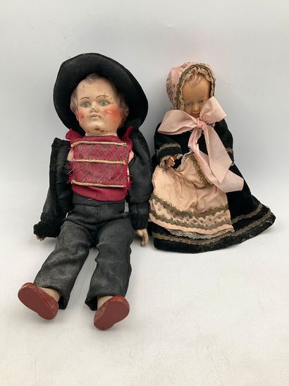 2 dolls in traditional Breton costumes. One,...