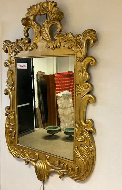 Glass with gilded frame and plant motif....