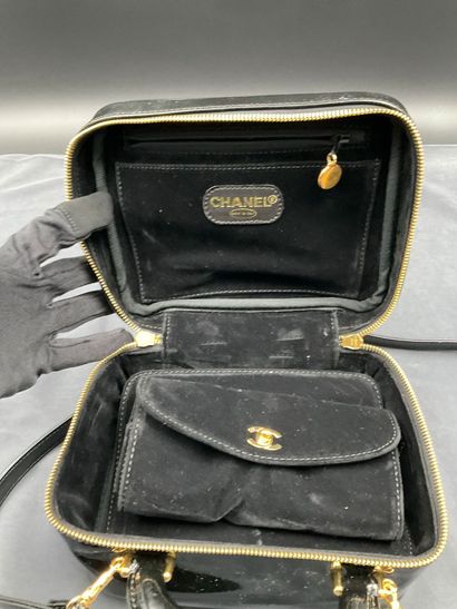 CHANEL. Black vinyl vanity case number 5100665....