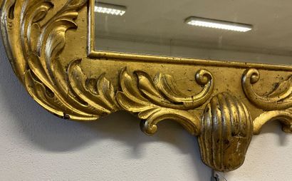 Glass with gilded frame and plant motif....