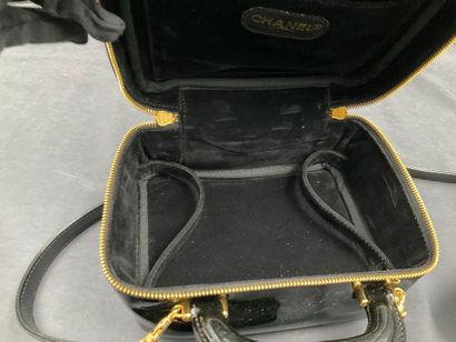CHANEL. Black vinyl vanity case number 5100665....