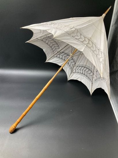 A cotton parasol on a bamboo stem base. A...