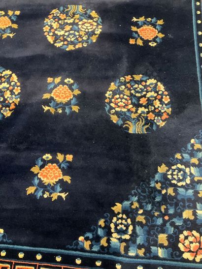Midnight-blue wool rug with pink floral design.
Dimensions:...