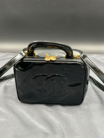 CHANEL. Black vinyl vanity case number 5100665....