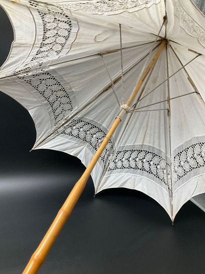 A cotton parasol on a bamboo stem base. A...